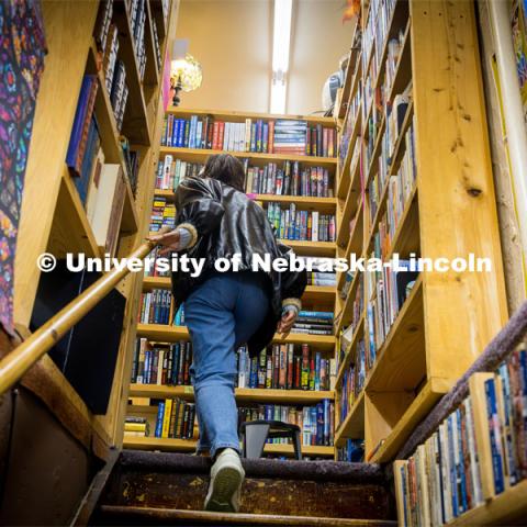 Ariana Joy Cobler walks up the stairs at A Novel Idea Bookstore. About Lincoln at A Novel Idea Bookstore. October 18, 2023. Photo by Kristen Labadie / University Communication.